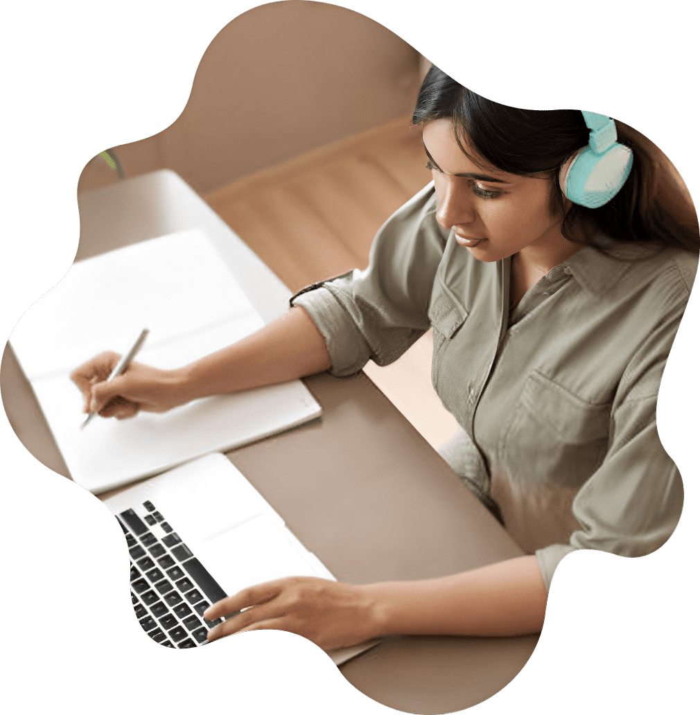 Woman studying with laptop and headphones.